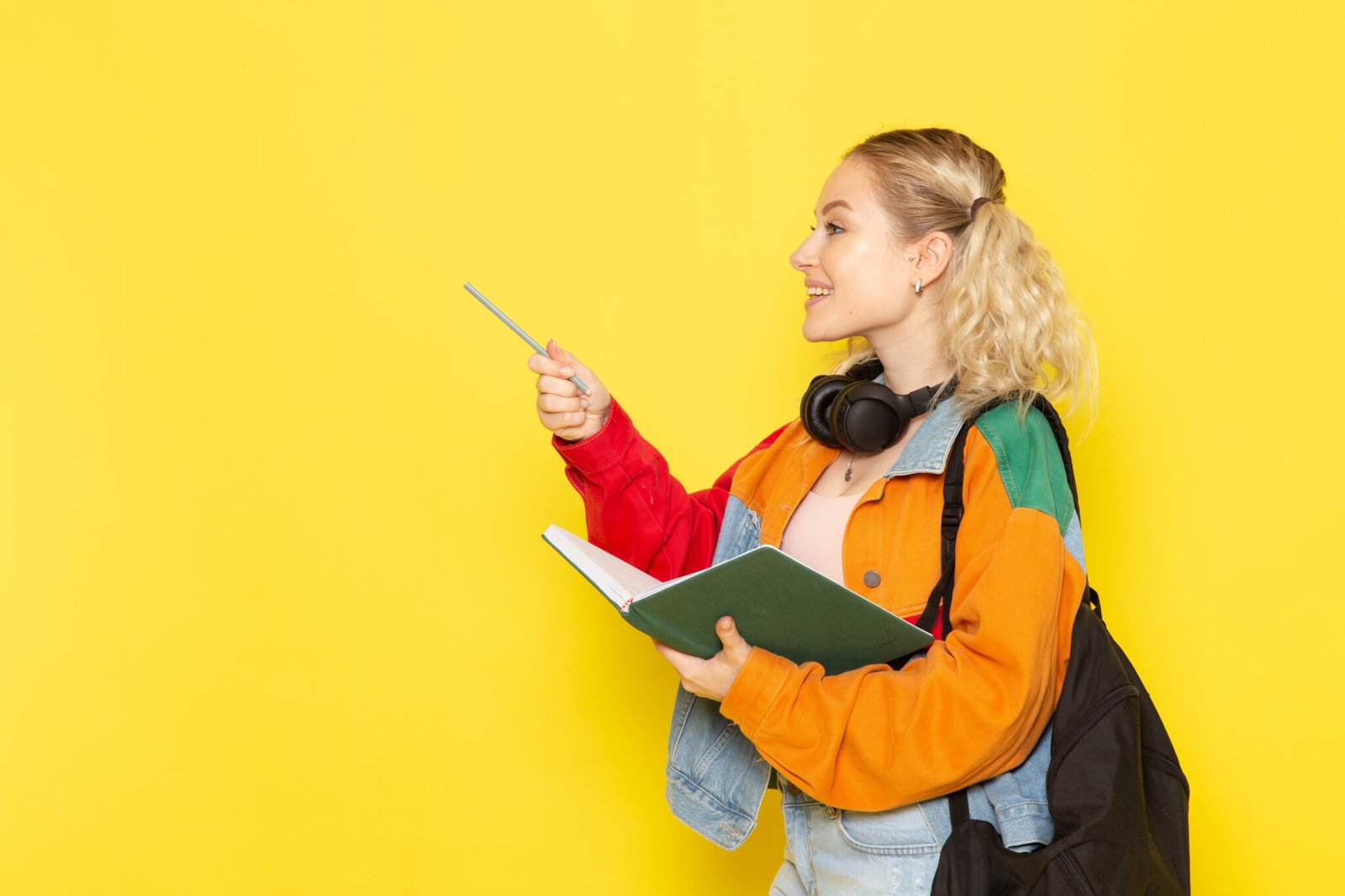 female-student-young-modern-clothes-holding-green-copybook-yellow